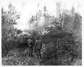 Tank dozer pushing Japanese tanks out of the road so that traffic may proceed. July 1944